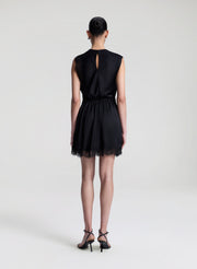 woman wearing black satin and lace mini dress