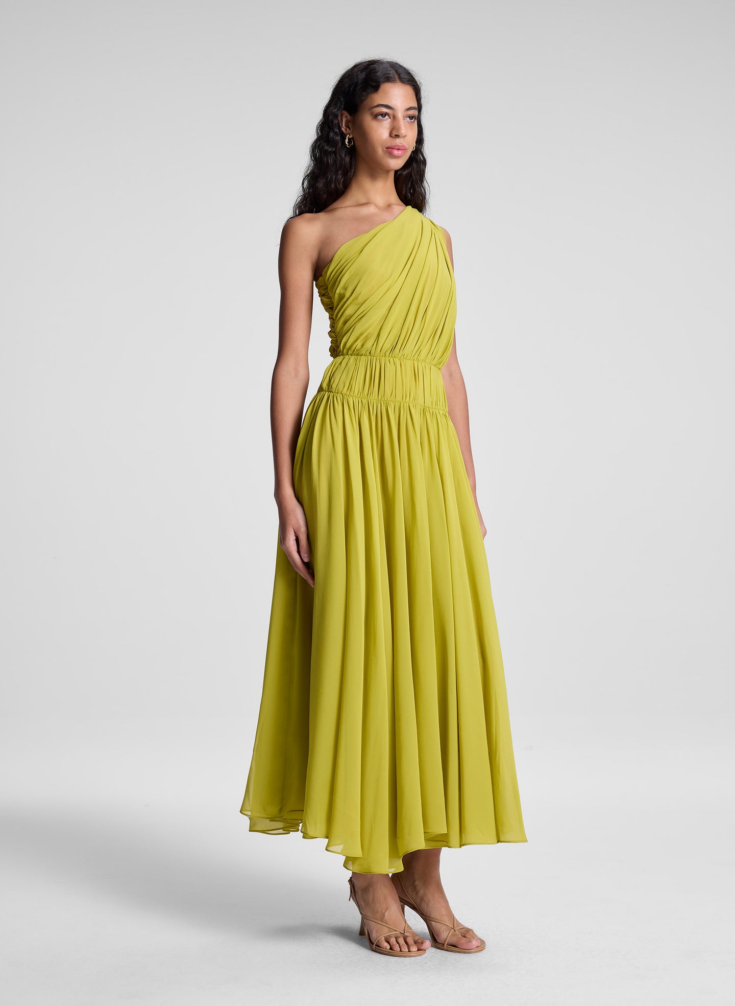woman wearing green one shoulder midi dress