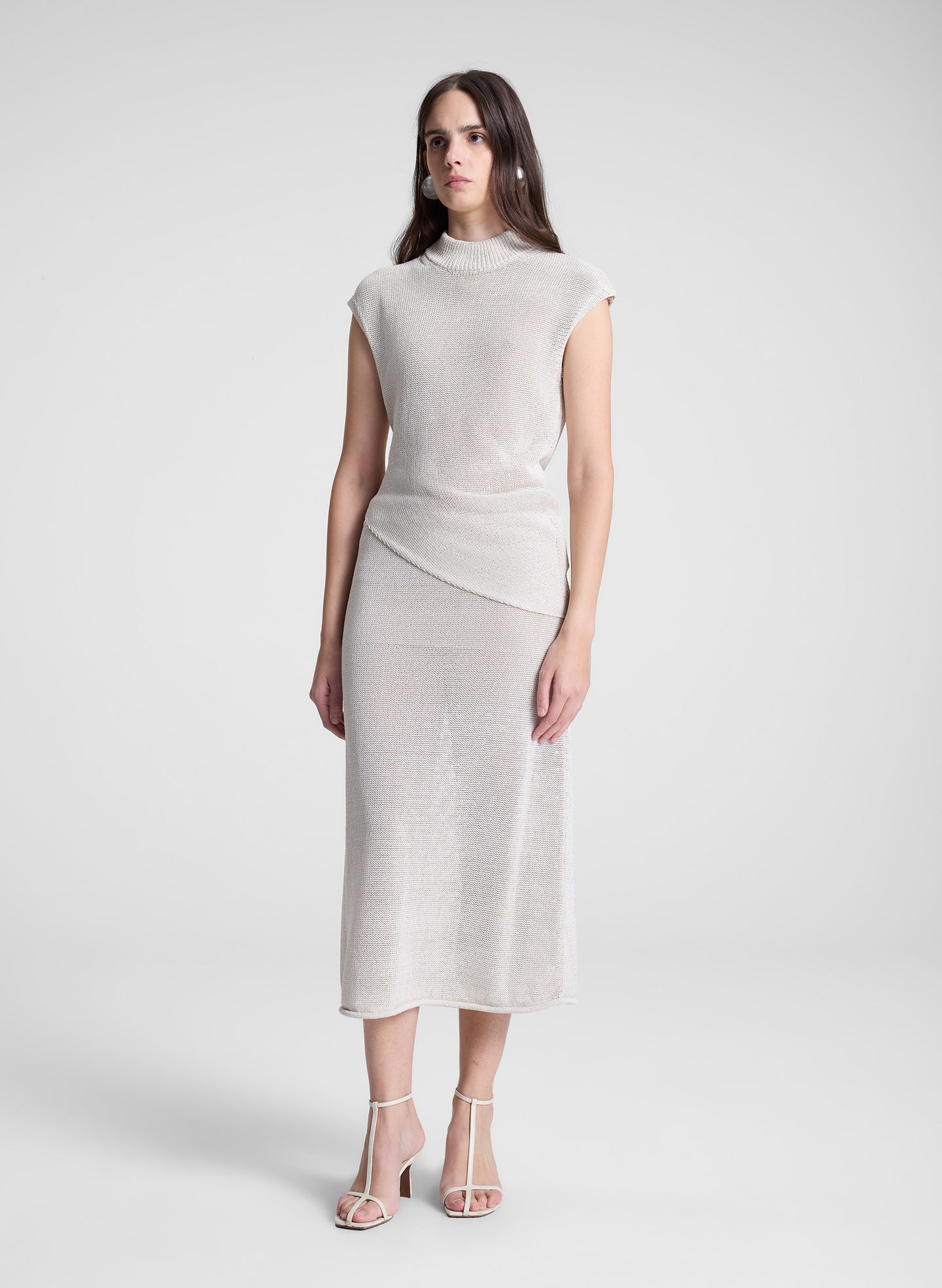 woman wearing cream knit skirt and matching top