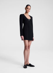 Woman wearing a black dress on a white background