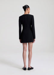 Person wearing a black dress on a white background