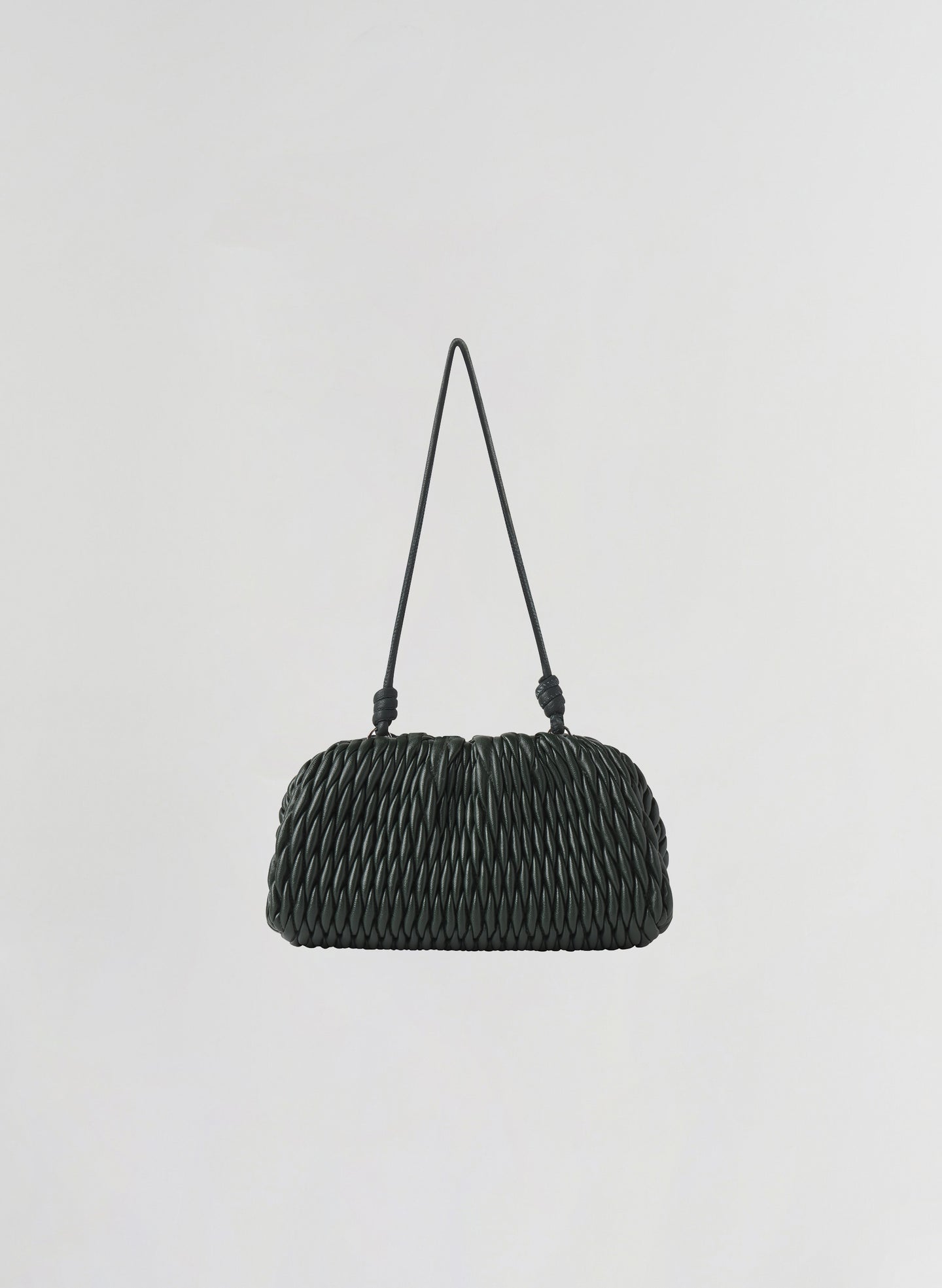 A small green woven leather shoulder bag with a single thin strap, photographed against a plain light gray background.