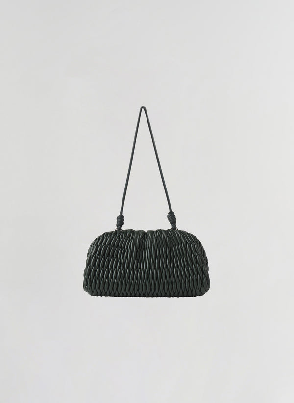 A small green woven leather shoulder bag with a single thin strap, photographed against a plain light gray background.