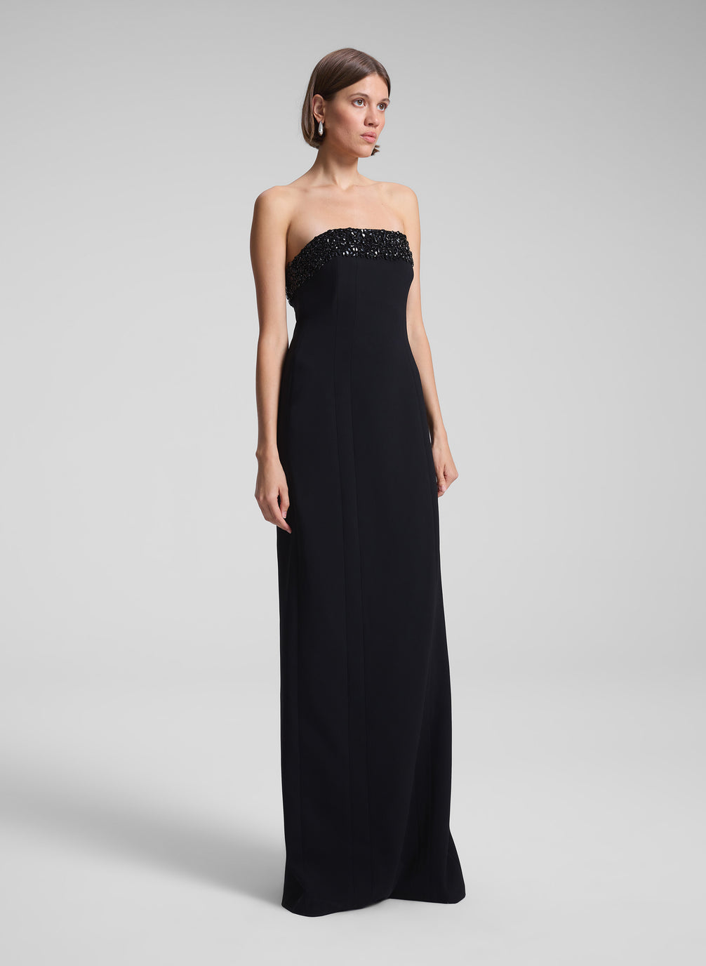 woman wearing black strapless embellished gown