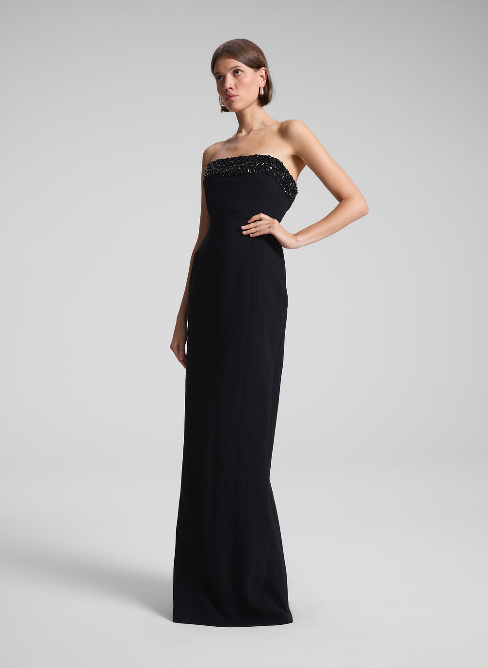 woman wearing black strapless embellished gown