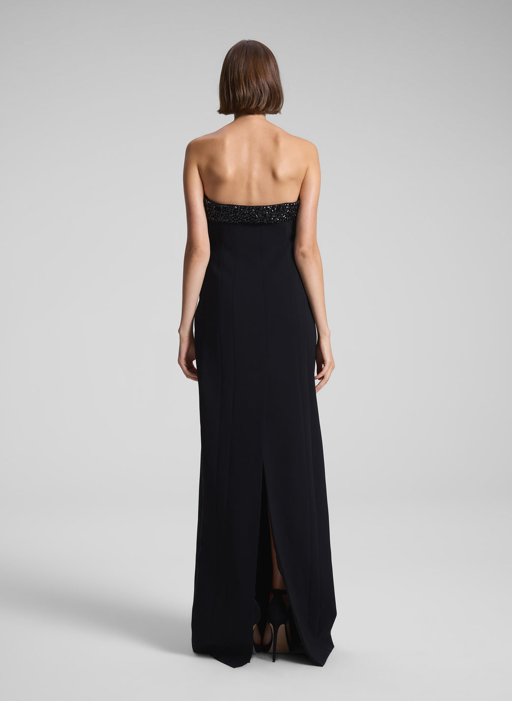 woman wearing black strapless embellished gown