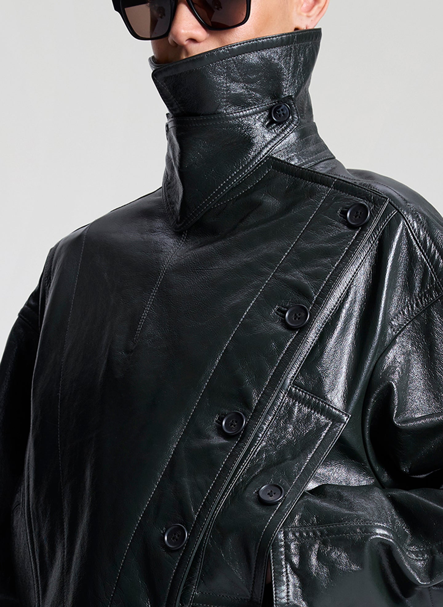 woman wearing green leather jacket and brown pants 