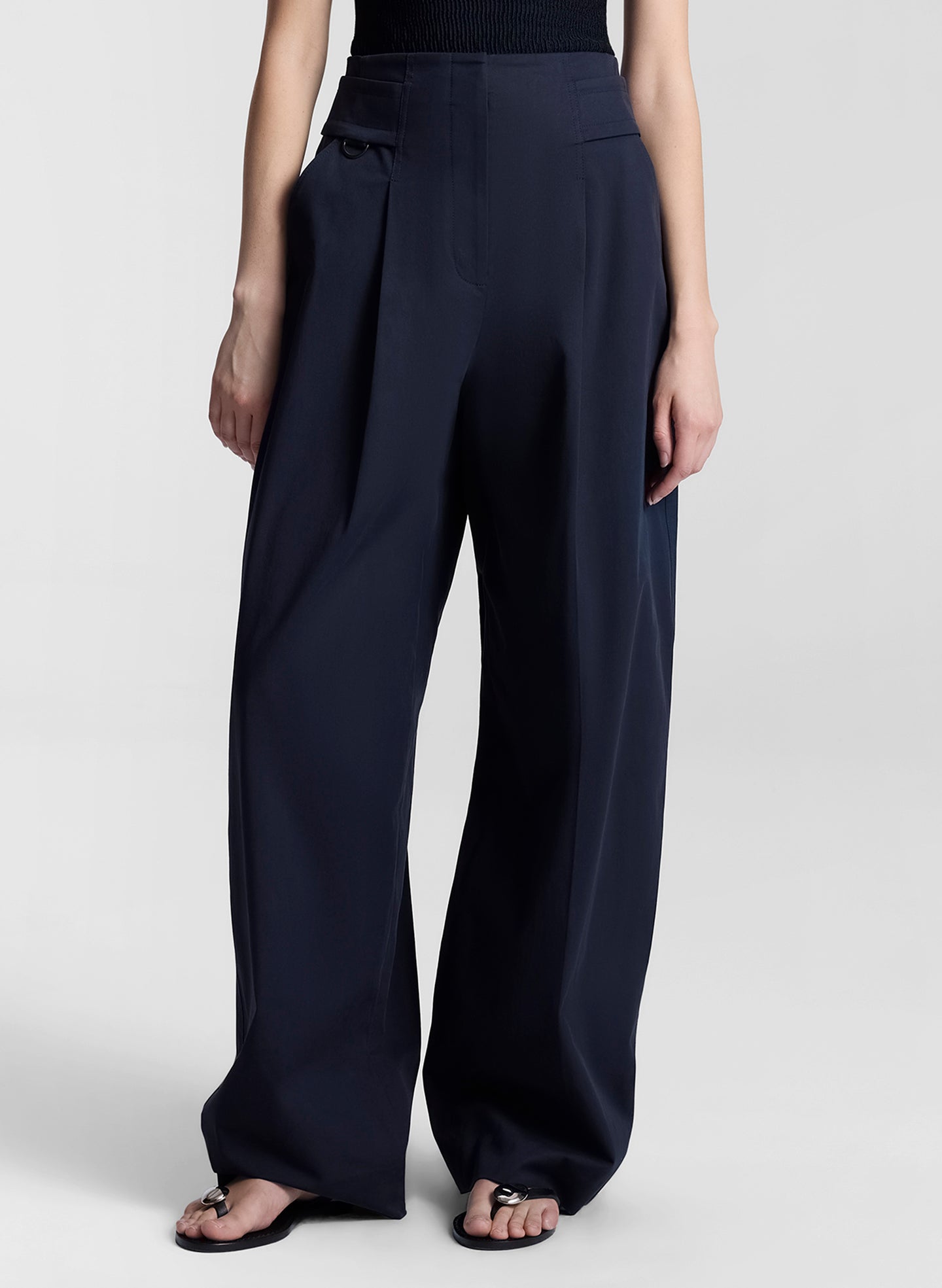 woman wearing black top and navy blue pants