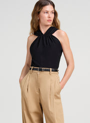 woman in black top and tan pants
