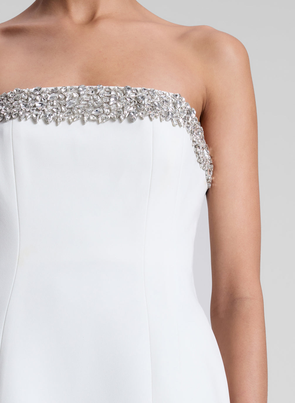 woman wearing white embellished strapless mini dress