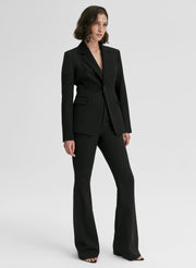 Woman wearing a black suit on a white background