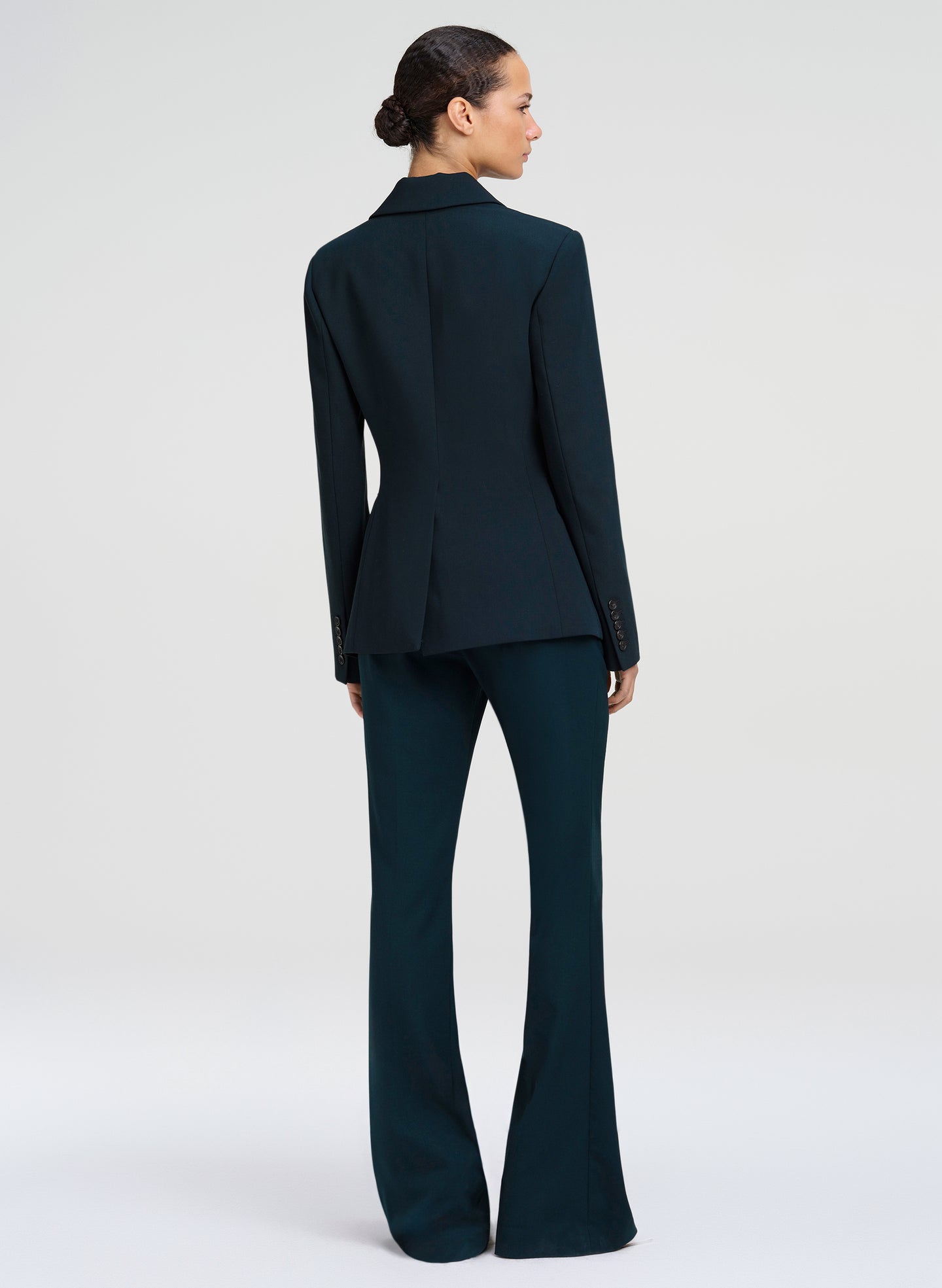 woman wearing dark green suit