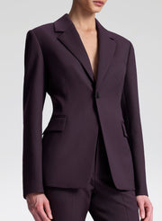 Purple suit jacket worn by a person on a light gray background