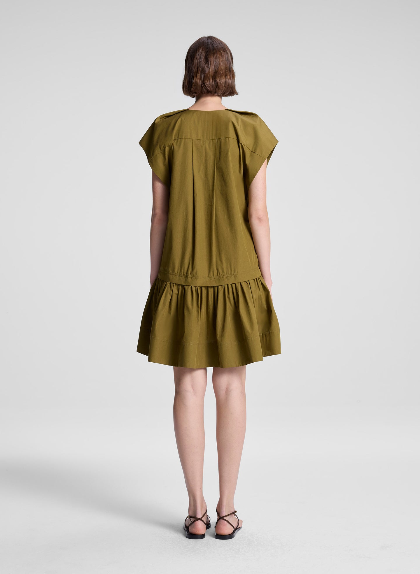 woman wearing green mini dress