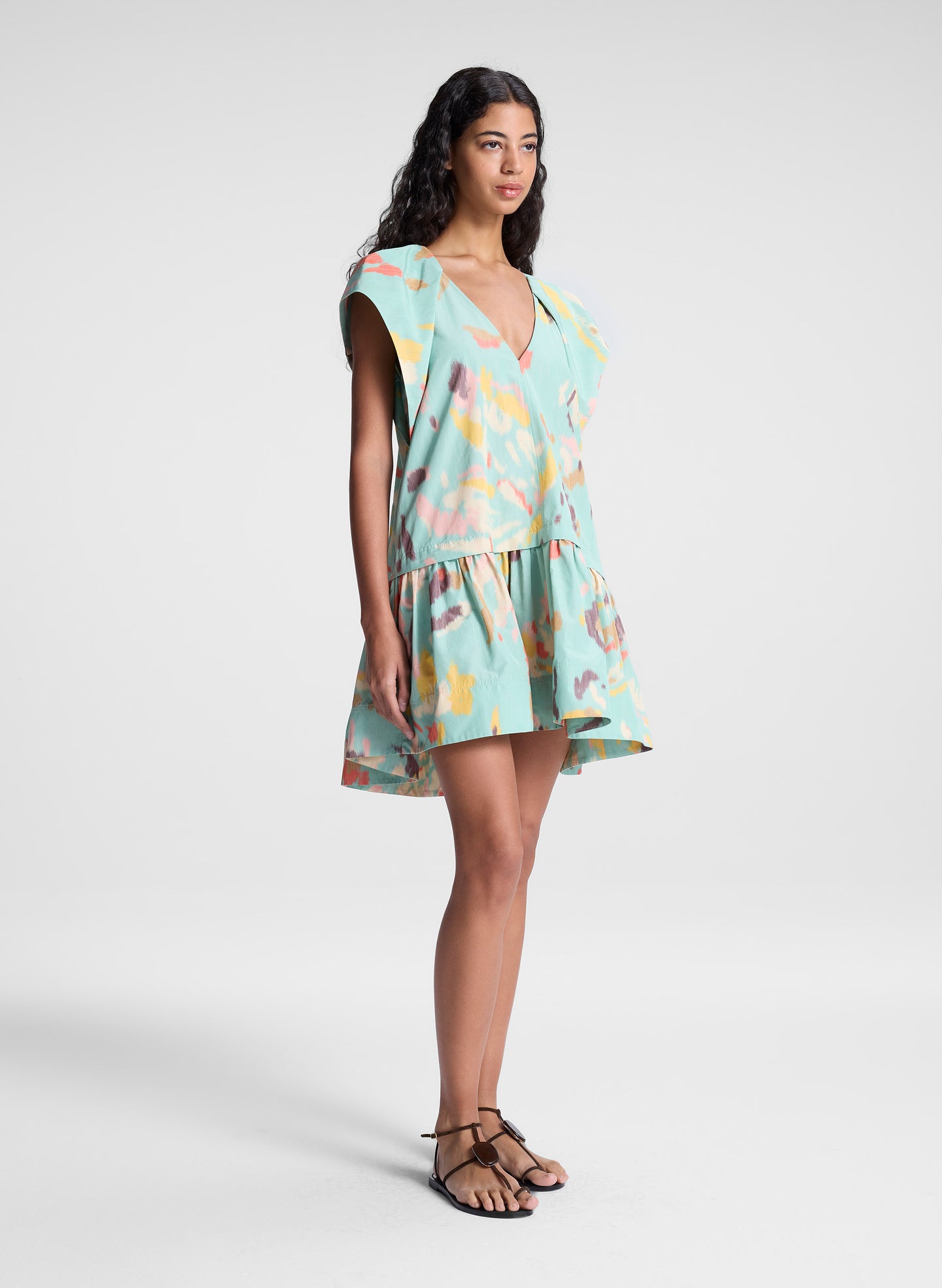 woman wearing aqua abstract printed mini dress