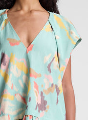 woman wearing aqua abstract printed mini dress