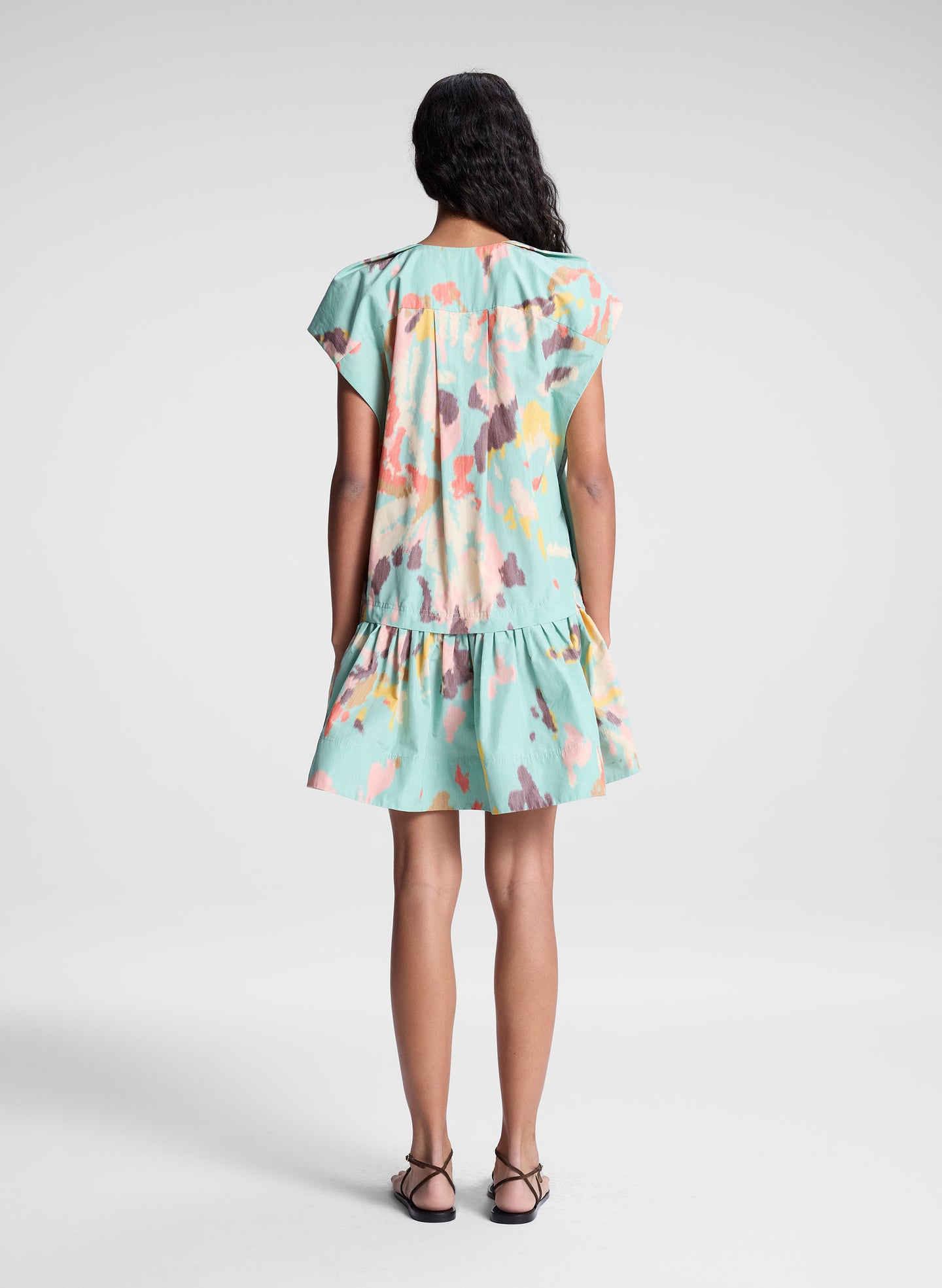 woman wearing aqua abstract printed mini dress