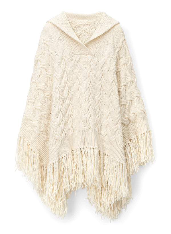 flat lay view of woman wearing cream cable knit poncho with fringe