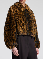 Leopard print faux fur jacket worn by a person on a white background