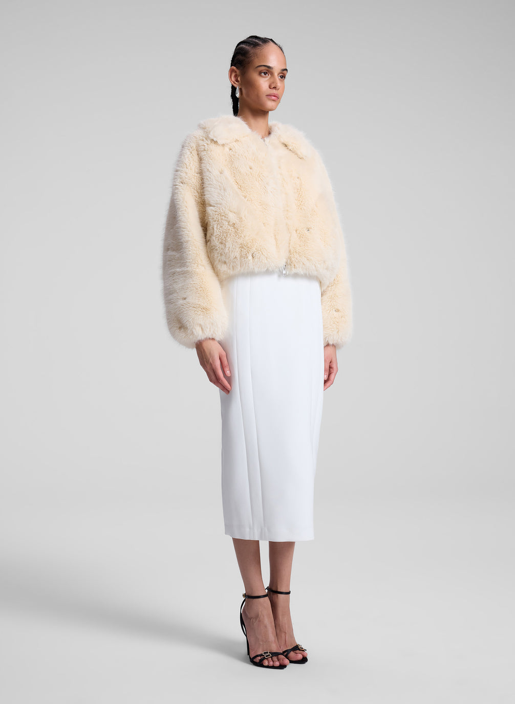 woman wearing cream faux fur jacket