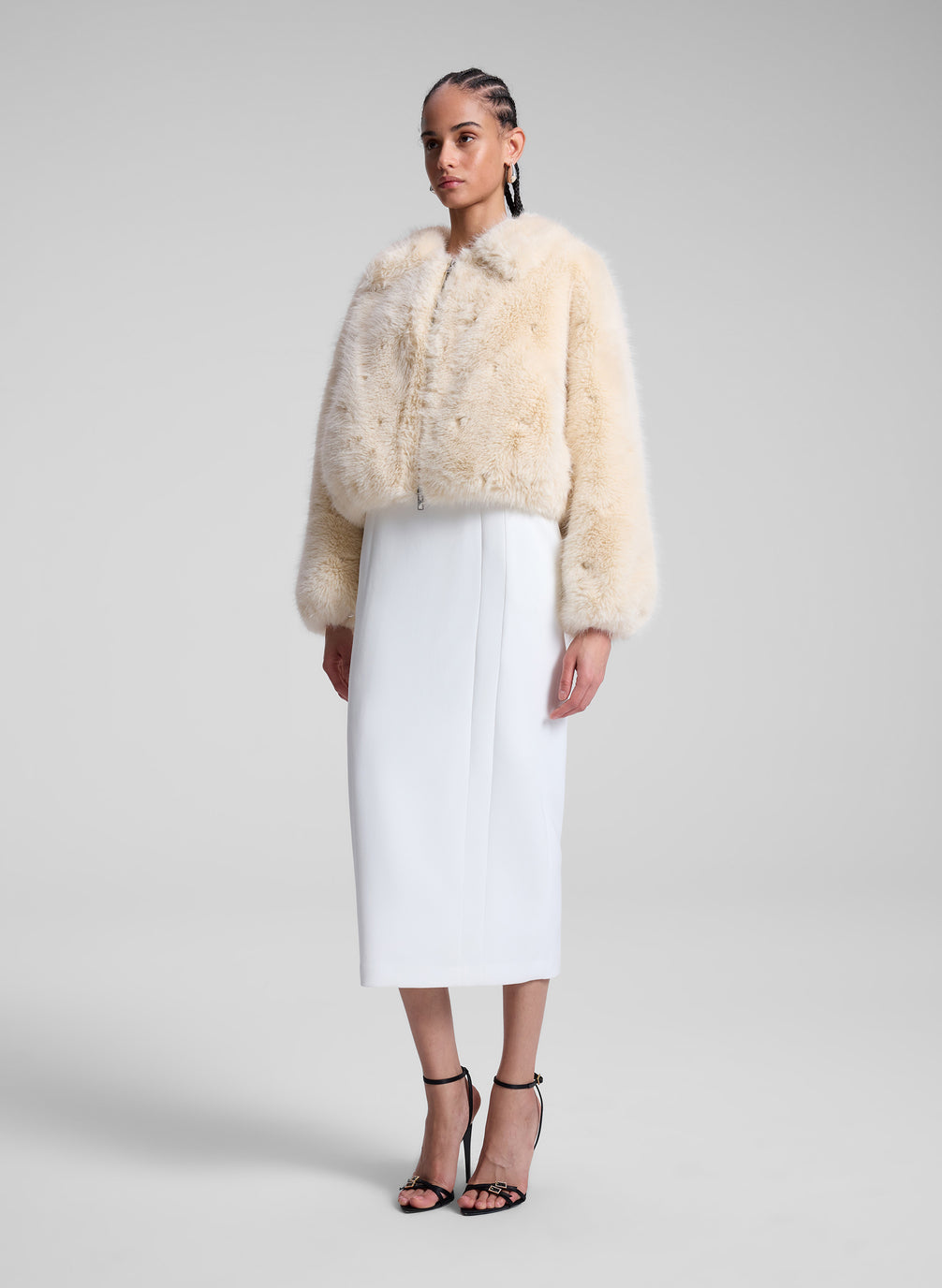 woman wearing cream faux fur jacket