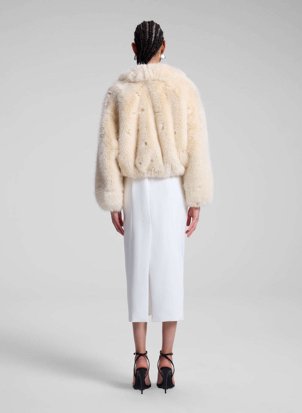 woman wearing cream faux fur jacket