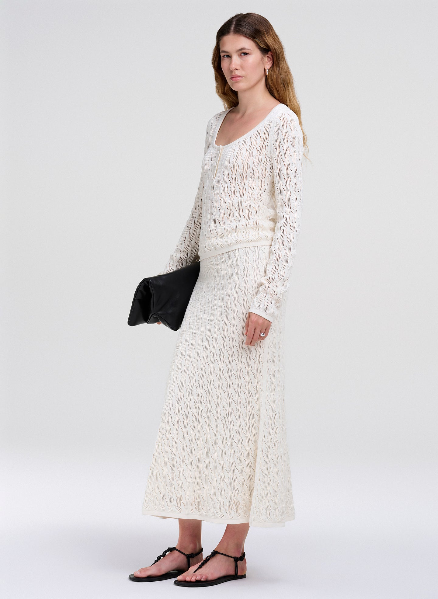 woman in cream top with matching skirt