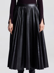 Black pleated skirt worn by a person on a white background