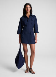 woman carrying navy blue raffia tote