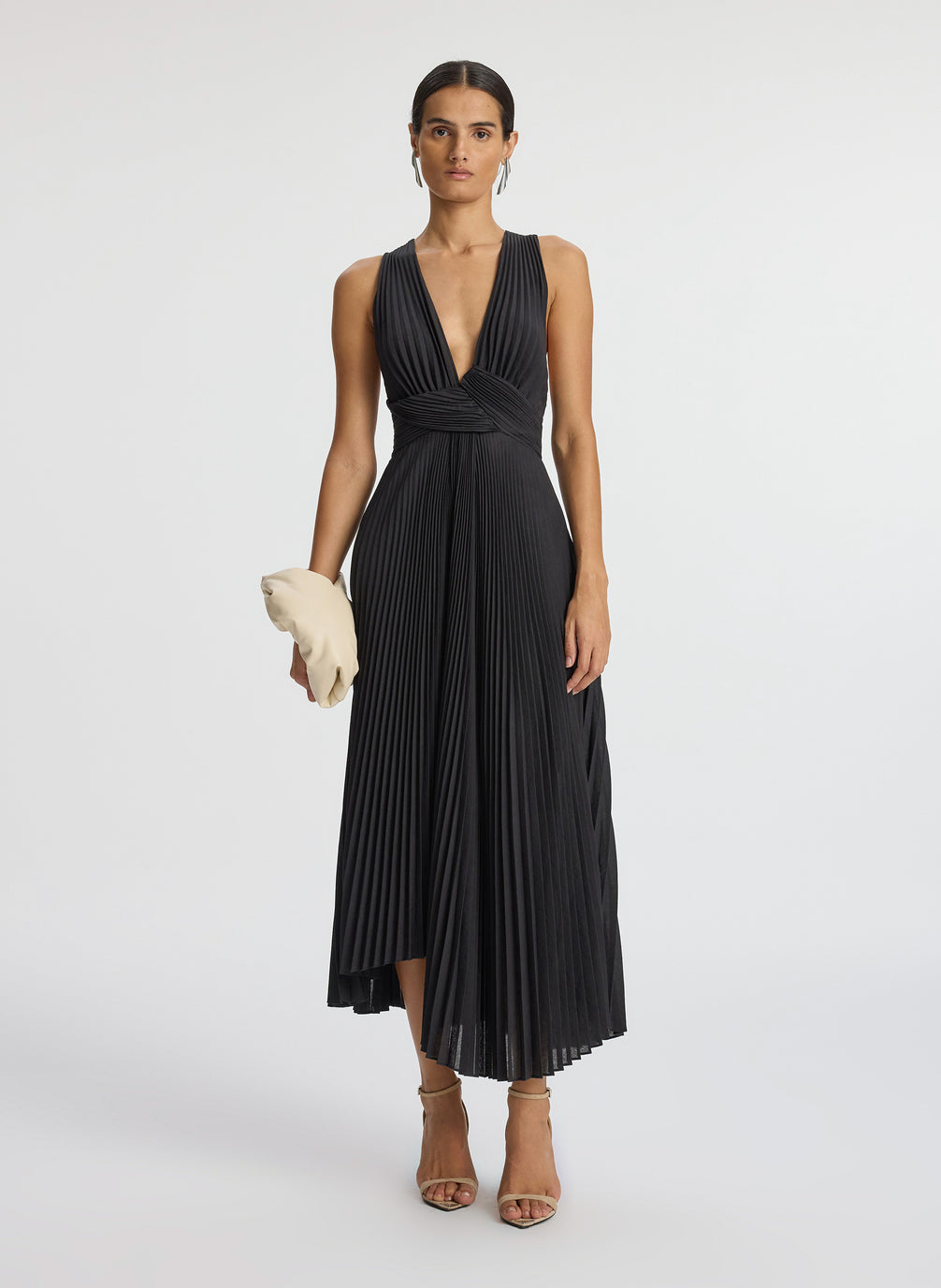 front view of woman wearing black deep v-neck pleated midi dress