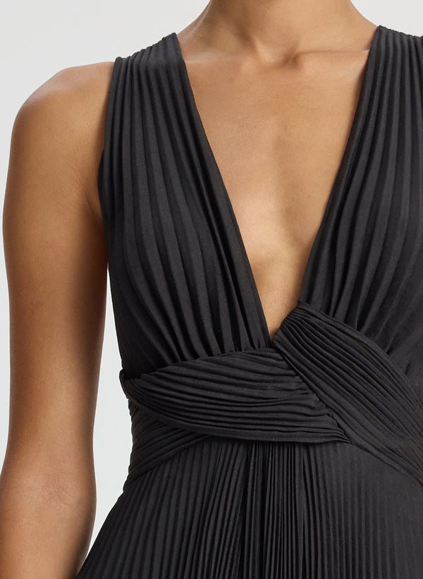 detail view of woman wearing black deep v-neck pleated midi dress