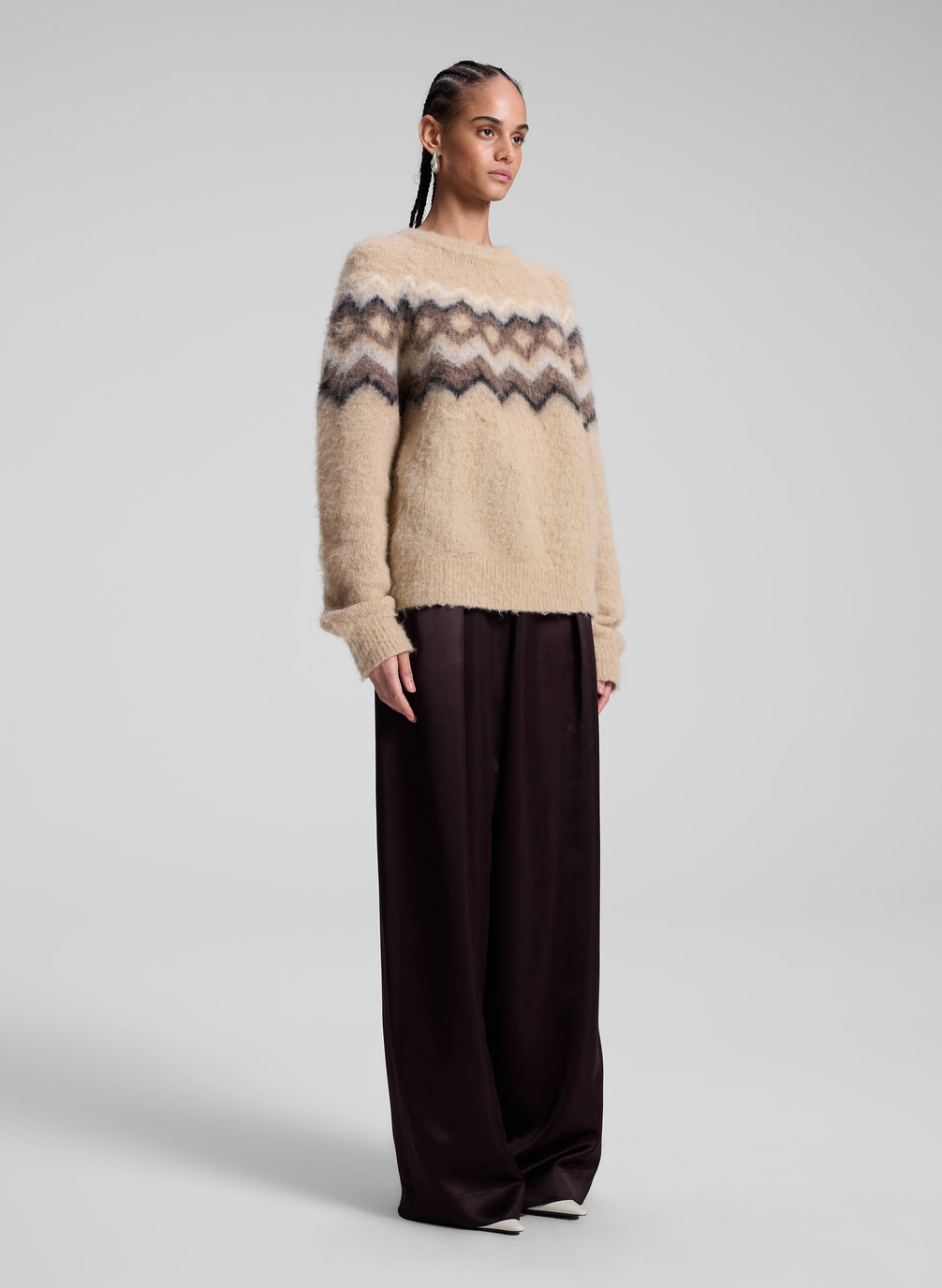 woman wearing taupe fairisle sweater and brown pants