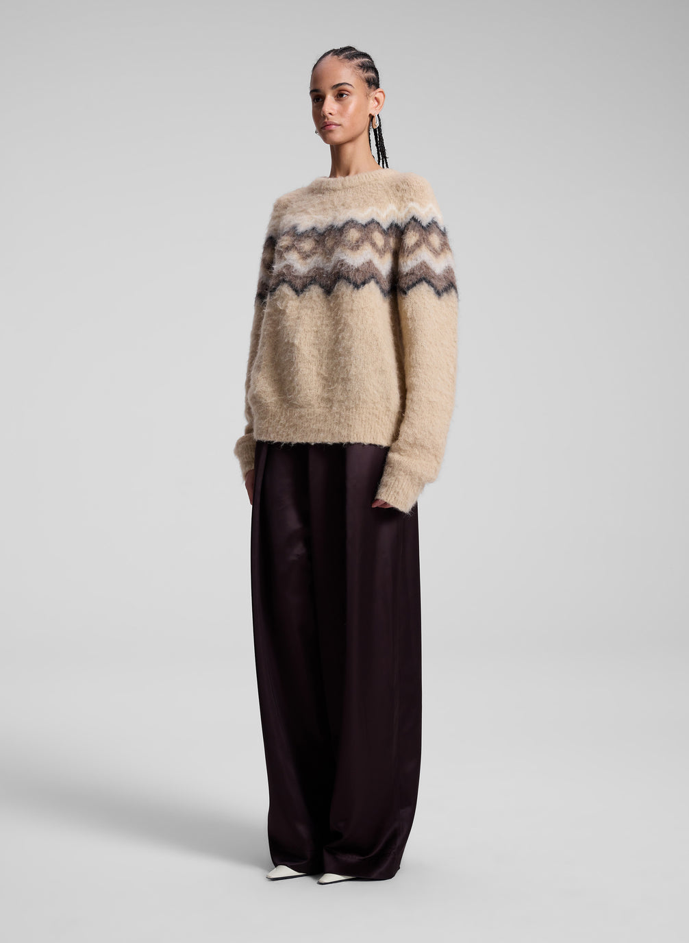 woman wearing taupe fairisle sweater and brown pants