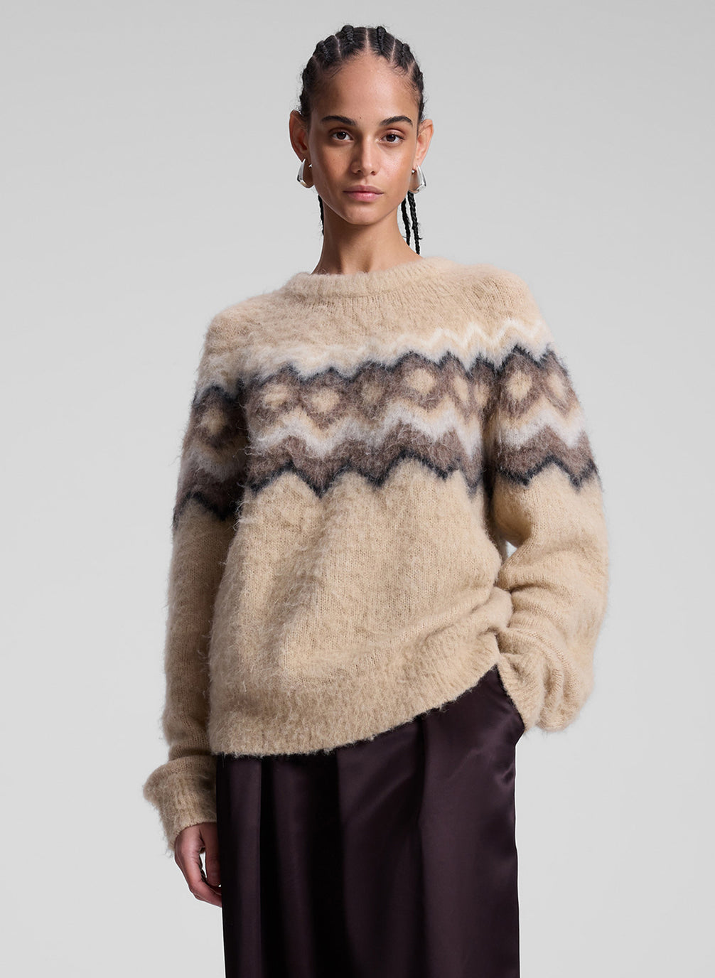 woman wearing taupe fairisle sweater and brown pants