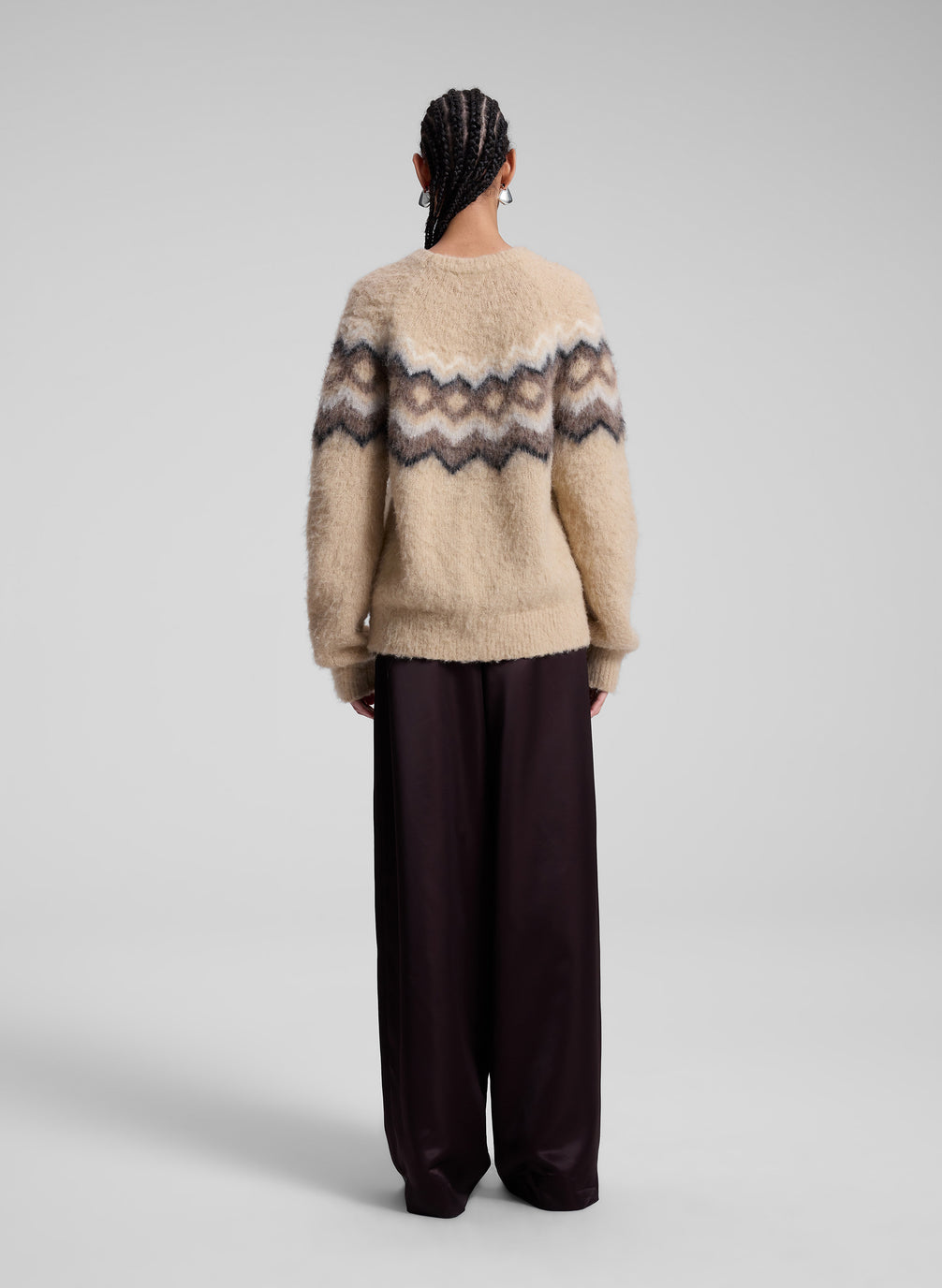 woman wearing taupe fairisle sweater and brown pants