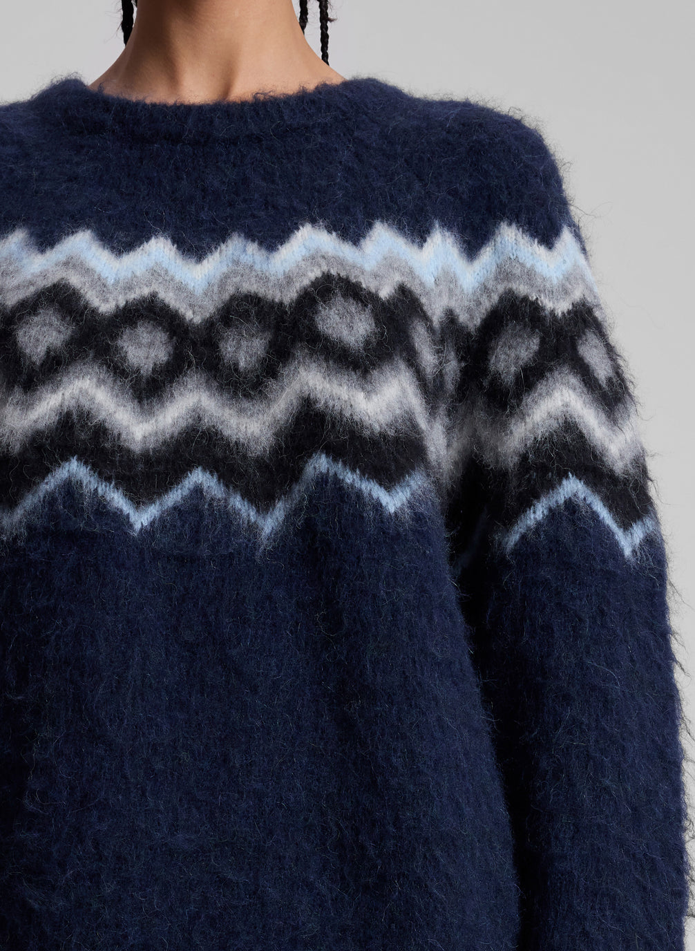 woman wearing navy blue fairisle sweater and grey mini skirt