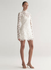 woman wearing white lace mini dress