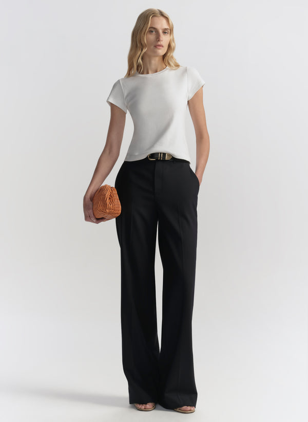 woman carrying orange handbag