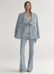 woman wearing blue suit and blue leather gloves