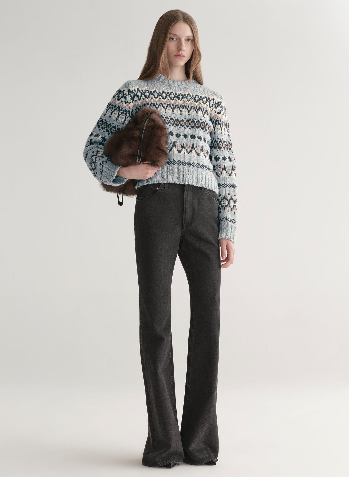 woman wearing blue sweater with black denim jeans