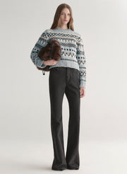 woman wearing blue sweater with black denim jeans