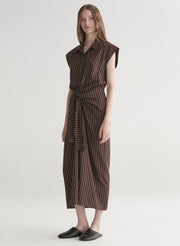 Woman wearing a brown striped dress on a white background