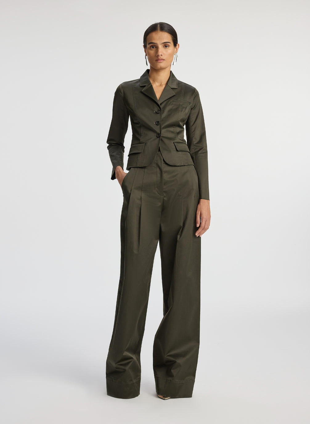 front view of woman in olive green sateen suit jacket and wide leg pants