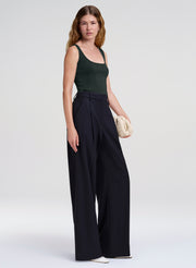 woman in green tank top and navy blue wide leg trousers