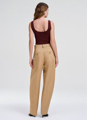woman in maroon top and beige pant
