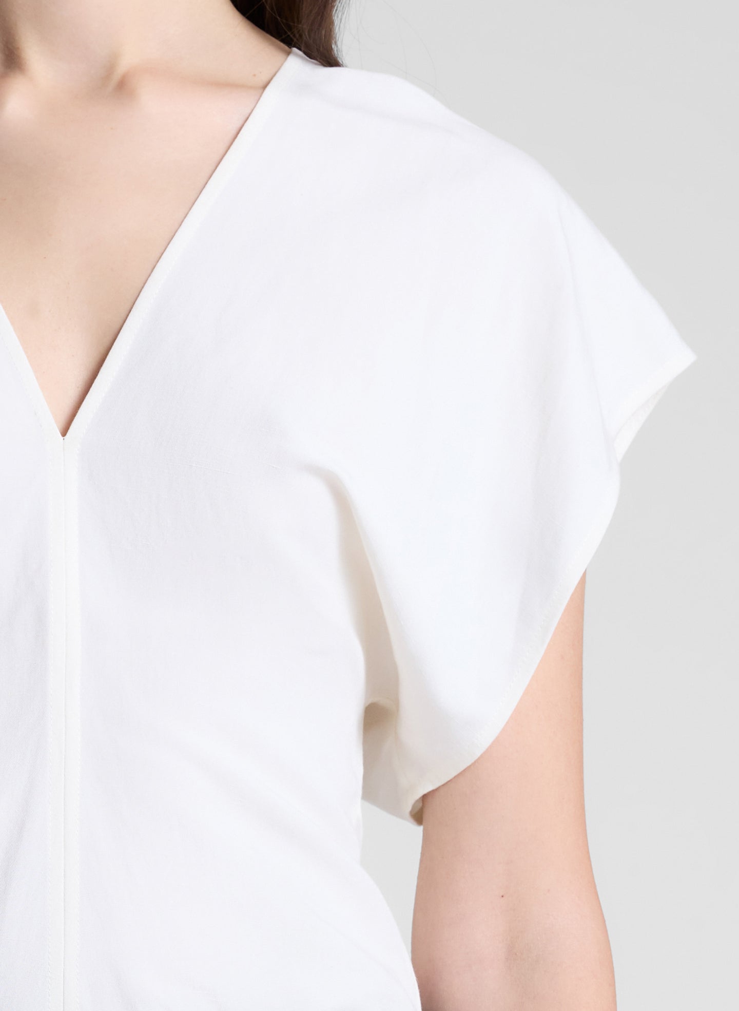 woman wearing white linen top and cream wide leg pant