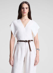 woman wearing white linen top and cream wide leg pant