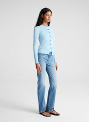 woman wearing light blue fine gauge cardigan and light blue denim jeans