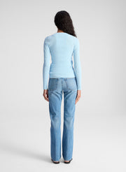 woman wearing light blue fine gauge cardigan and light blue denim jeans