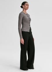 woman wearing grey ribbed cardigan and black pants